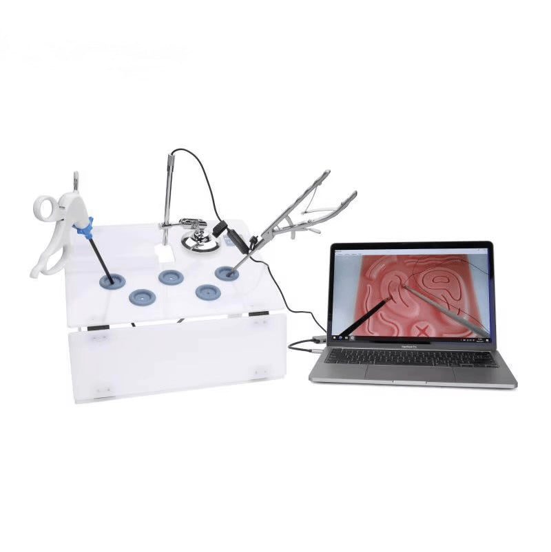 The Endo Trainer laparoscopic simulator box connected to a laptop showing the HD camera feed